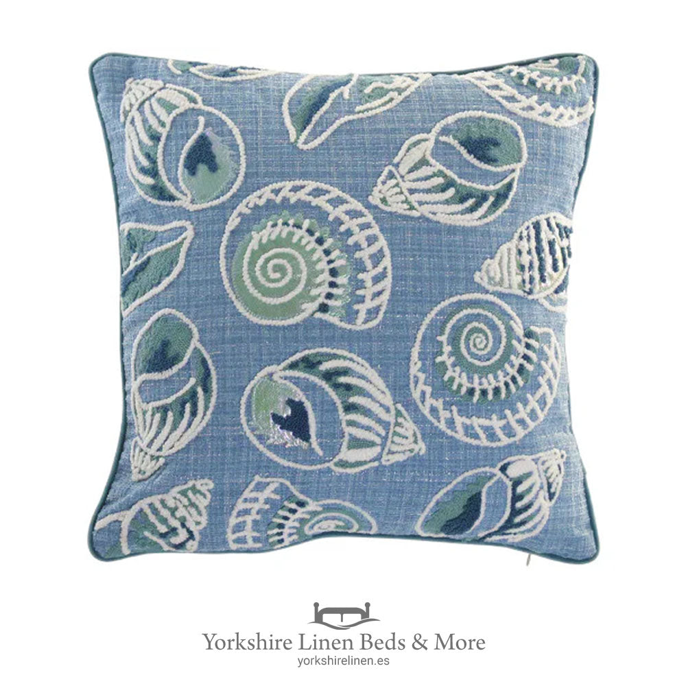 Embroidered Beach Vibes cushion featuring a collection of sea shells in various shades of blue on a natural linen-look background – 45x45cm – Yorkshire Linen Mijas Costa.